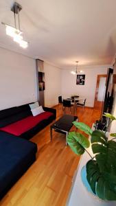 a living room with a couch and a table at LUMARE LUANCO - A 5 min de la playa a pie - Parking incluido in Luanco