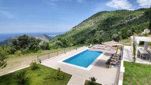 a swimming pool with a view of a mountain at Villa Adria Heights in Pečurice