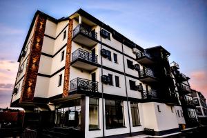 a black and white building with windows and balconies at New Modern Apartments with Private Parking in Leštane