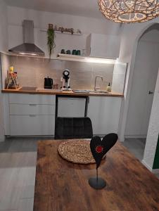 a kitchen with a table with a heart chair on it at L'Obernai in Obernai +17 photos