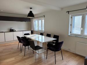 a kitchen and dining room with a table and chairs at 24 h chek in big house in Copenhagen