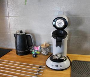 a coffee maker with a clock on top of it at L'Obernai in Obernai