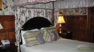 a bedroom with a bed with a canopy at A Cambridge House Inn in Cambridge