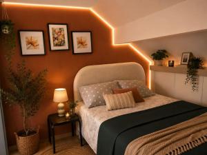 a bedroom with a bed with lights on the wall at Elegancia del JJM in Annemasse +6 photos