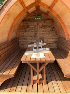a wooden room with a table in a sauna at Hill View Glamping Hut in Tregaron