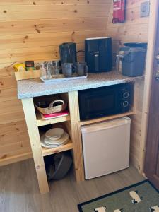 a small kitchen with a counter and a stove at Hill View Glamping Hut in Tregaron