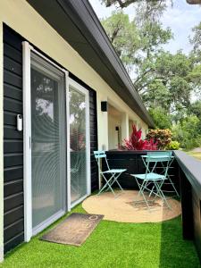 a patio with a table and chairs on the side of a house at Tropical Luxe Villa-Near Airport, Minutes to Lido key beach, Downtown and Dining in Sarasota