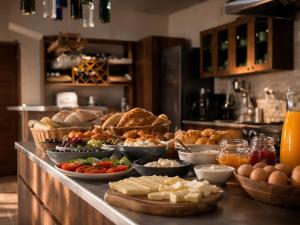 a buffet with many different types of food on a counter at Pesvebi Design Hotel and Cellar in Borjomi