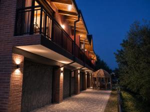 a building with a balcony on the side of it at Pesvebi Design Hotel and Cellar in Borjomi