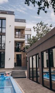 an exterior view of a house with a swimming pool at Клубний дім D2 in Chornomorsk