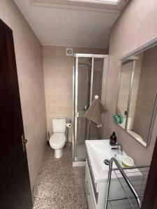 a bathroom with a toilet and a sink and a shower at Casa con encanto en Darnius in Darnius +27 photos