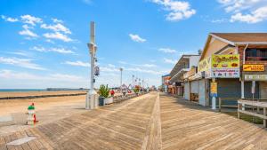 a boardwalk on a beach with shops and a fire hydrant at Boardwalk One in Ocean City