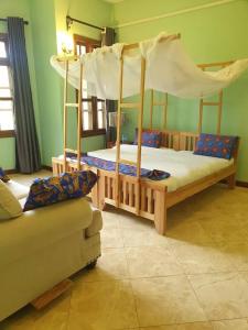 a bedroom with two bunk beds and a couch at Kilimanjaro pazuri summit villas 1 in Msaranga