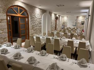 a large room with tables and chairs in it at Hotel Park Drniš in Drniš