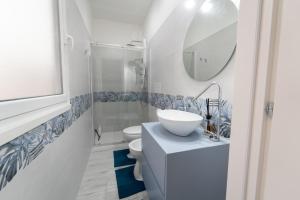 a bathroom with a sink and a toilet and a mirror at Sogno Di Mezzanotte in Taranto +29 photos