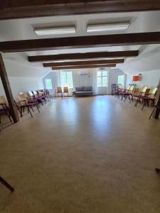 a large room with chairs and a stage in it at Mössebergs vandrarhem in Falköping