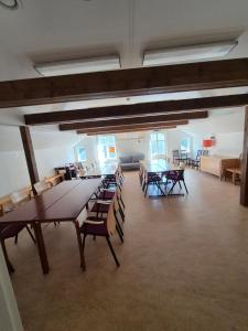 a large room with tables and chairs in a building at Mössebergs vandrarhem in Falköping