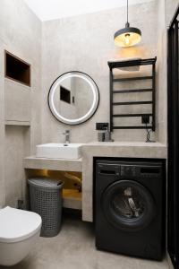 a bathroom with a washing machine and a sink at Mayak Bamboo Beach Apartments in Kobuleti +29 photos