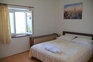 a bedroom with a bed with a towel on it at Blazo jedan in Neviđane