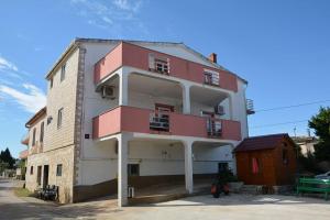 a red and white building next to a building at Blazo jedan in Neviđane