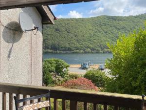 a view of a lake from the balcony of a house at The Welsh Hideaway in Llanberis