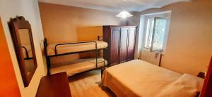 a small room with two beds and a window at Casa di Giò in Capracotta