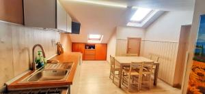 a kitchen with a sink and a table with chairs at Casa di Giò in Capracotta