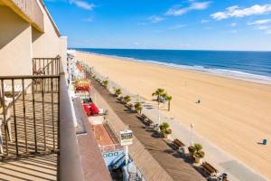 a view of the beach from a balcony of a building at Boardwalk One in Ocean City