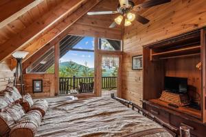 a bedroom with a large bed and a large window at Fox Ridge #37 by Venture Smoky Mountains in Sevierville
