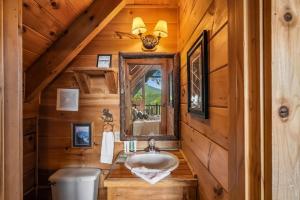 a bathroom with a sink and a mirror in a cabin at Fox Ridge #37 by Venture Smoky Mountains in Sevierville +92 photos