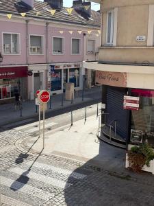 a stop sign in the middle of a street at Gengoult 3 in Toul +5 photos