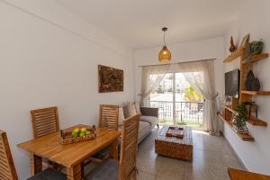 a living room with a table and a couch at Olive Grove Apartments in Larnaca