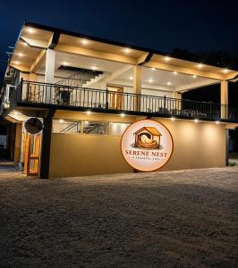 a building with a sign in front of it at night at Serene Nest Hotel in Gilgit +4 photos