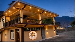 a large building with a balcony on top of it at Serene Nest Hotel in Gilgit