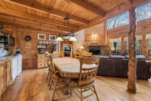 a dining room and kitchen with a table and chairs at Hoot n Hollar #31 by Venture Smoky Mountains in Sevierville