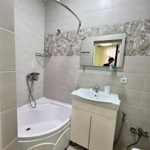 a bathroom with a sink and a toilet and a mirror at Атлантис in Chon-Sary-Oy +4 photos