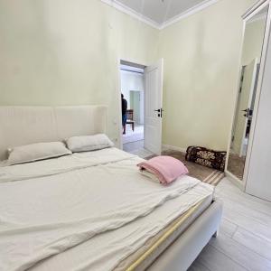 a white bedroom with a large bed in a room at Атлантис in Chon-Sary-Oy