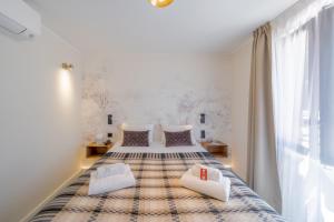 a bedroom with a large bed with two pillows at Logis Hotel de l'Artuby in Séranon +22 photos