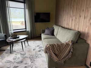a living room with a couch and a table at Flakstad beach house Silo B in Vareid