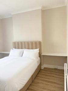 a bed with white sheets and pillows in a room at Central Room to Rent in Plymouth