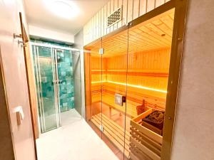 a walk in shower with a glass door in a bathroom at Apartmány Perninský Dvůr in Pernink +47 photos