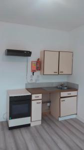 a kitchen with white cabinets and a black stove at The Garve Flats in Garve