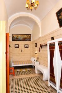 a living room with a couch and a bed at El Hamra Maison Traditionnelle in Mahdia +9 photos
