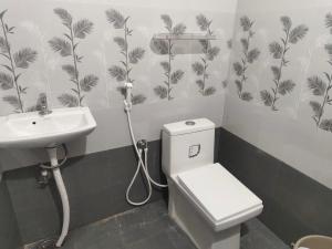 a bathroom with a toilet and a sink at Kavitha Residency in Virudunagar