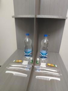 two bottles of water and toothbrushes in a refrigerator at Kavitha Residency in Virudunagar