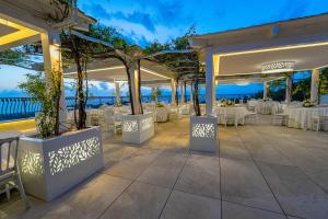 an outdoor dining area with tables and chairs at San Lorenzo - Boutique Hotel & SPA in Lettere