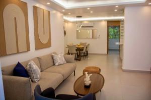 a living room with a couch and a table at Condo in Puerto Plata in San Felipe de Puerto Plata