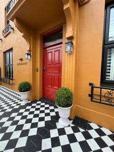 a red door on a building with a checkered floor at the Continental Boutique Residence in Galway