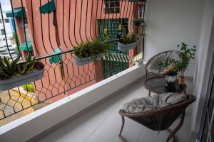 a balcony with potted plants on a fence at Condo in Puerto Plata in San Felipe de Puerto Plata