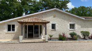 a white brick house with an open door at Maison Thierry in Pierre Penot